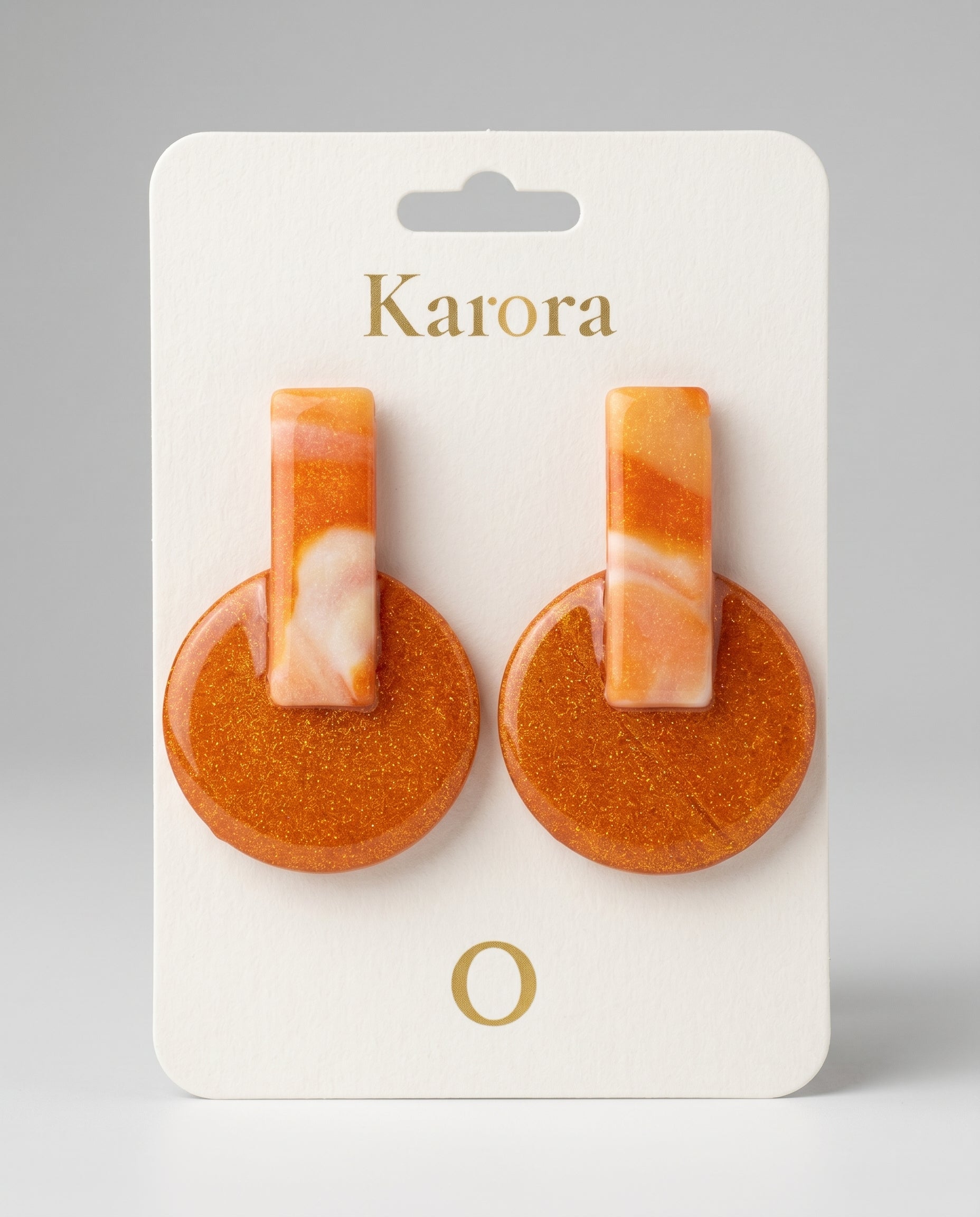 Pendientes Kaiora Coral Salvaje geométricos marmoleados naranjas y crema con purpurina