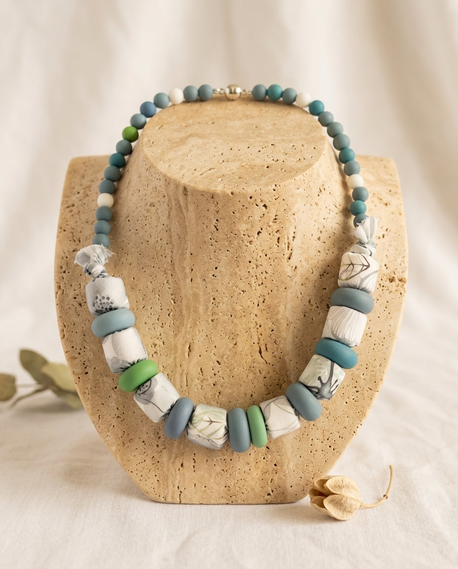 Collar Kaiora Lago con cuentas textiles botánicas y de silicona azules y verdes